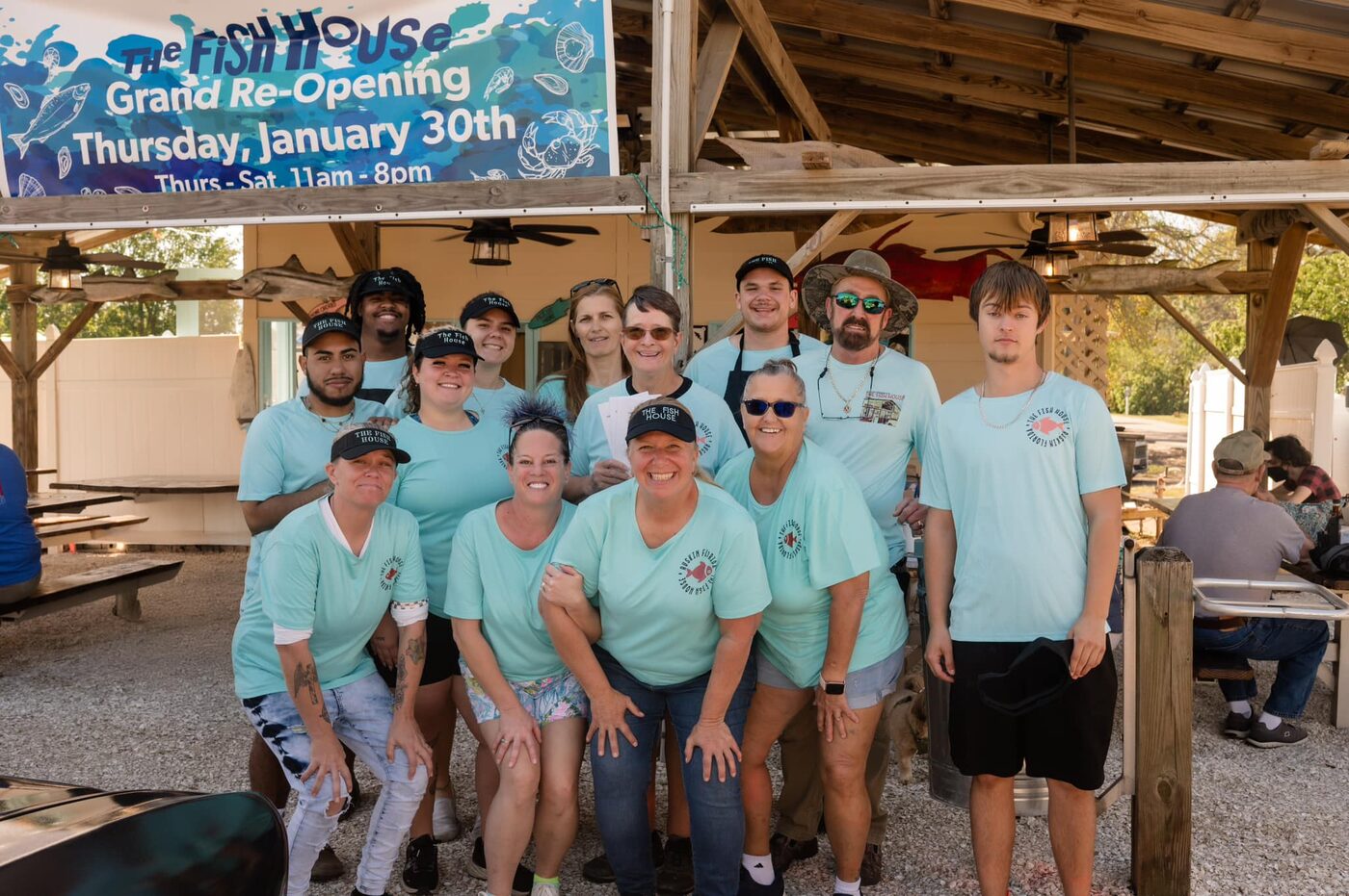 The Fish House crew in matching shirts under the covered seating area on grand re-opening day